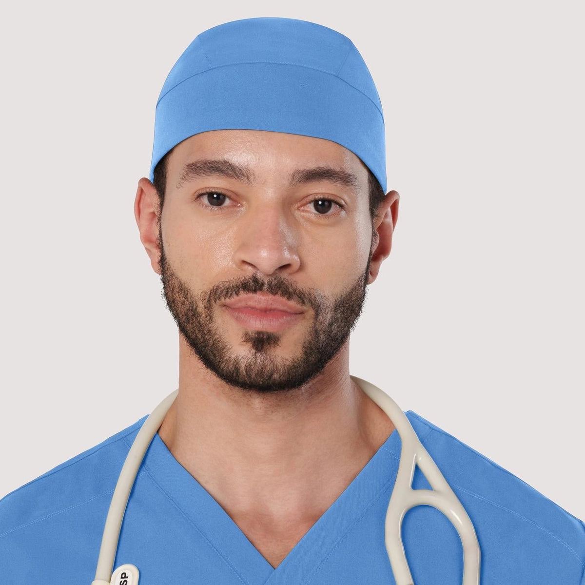 Male model wearing a clinical blue scrub cap